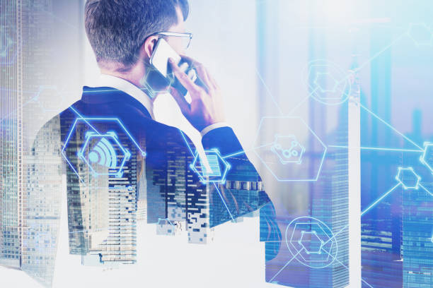 istock Businessman on phone in office, internet icons 1169640971