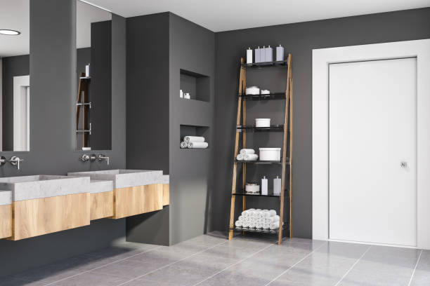 istock Corner of grey bathroom, double sink and shelves 1169641925