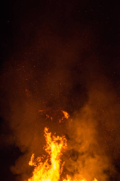 istock Fire sparks particles with flames isolated on black background. 1169643270
