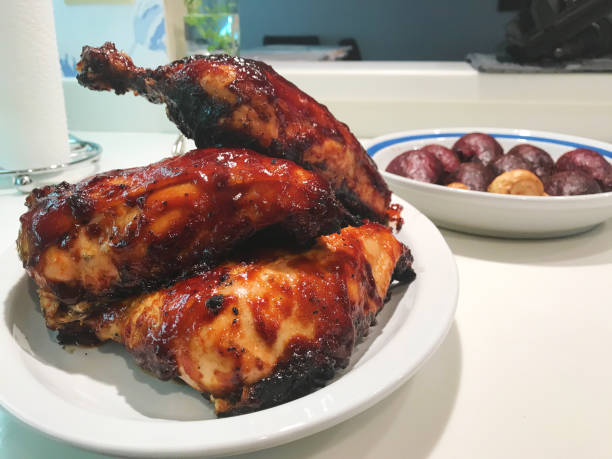 on a plate ready to be served with side dish barbequed chicken cooked on a grill with sauce sitting on kitchen counter  (Shot with iPhone 7 Plus 12mp 4032 × 3024 photos professionally retouched - Lightroom / Photoshop)