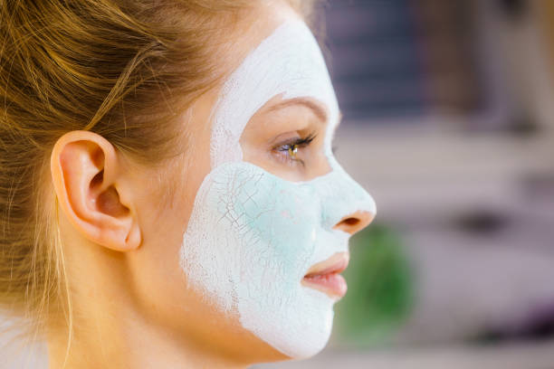 istock Girl with green mud mask on face 1169644302