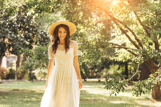 istock Happy girl walking through the summer park 1169644400