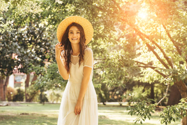 istock Happy girl walking through the summer park 1169644430