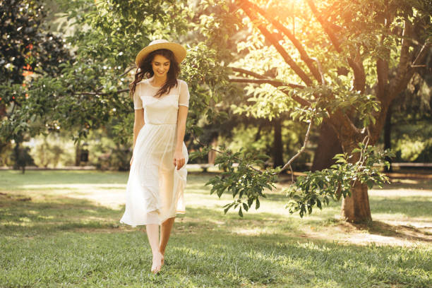 istock Happy girl walking through the summer park 1169644468