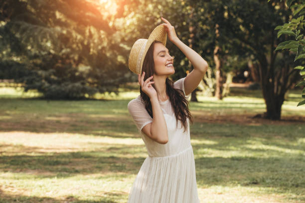 istock Happy girl walking through the summer park 1169645128