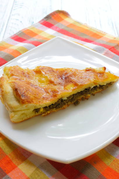 istock A piece of cake with liver and egg on a white plate. 1169645131