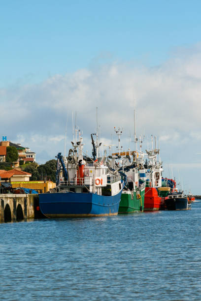 istock Boats docked in a harbor with a cloudy blue sky 1169647250