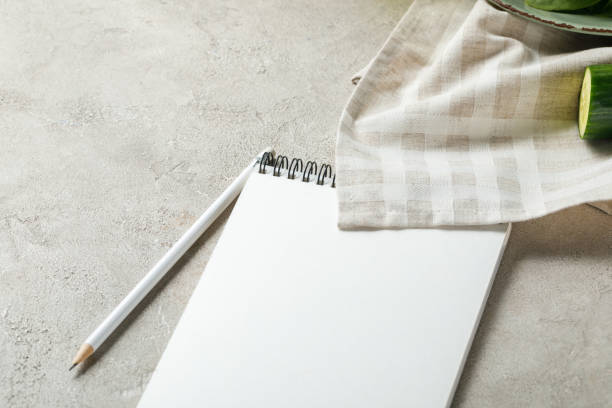 istock empty notebook with pencil on grey textured surface near napkin and cucumber, ketogenic diet menu 1169647831