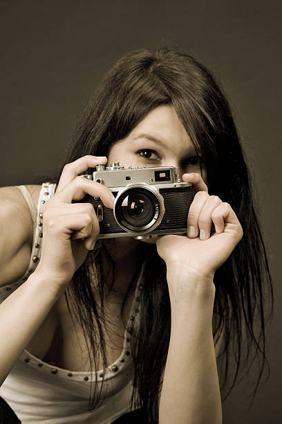 istock Beautiful photographer, focus on camera, sepia 116965026