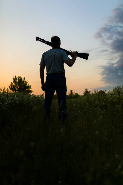 istock A man holds a gun on his shoulder 1169655231
