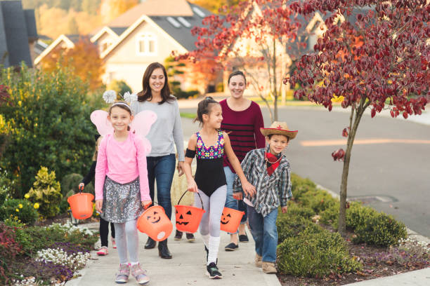 istock Multiethnic group of kids trick or treating 1169655332