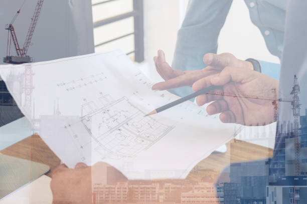istock architect engineer working on house blueprint of real estate project. building construction concept 1169656359