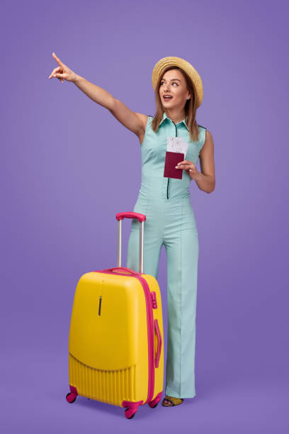 istock Amazed female traveler pointing away 1169656519