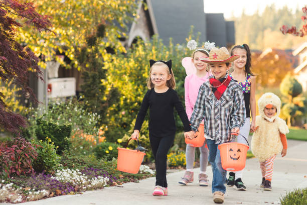 istock Multiethnic group of kids trick or treating 1169657485
