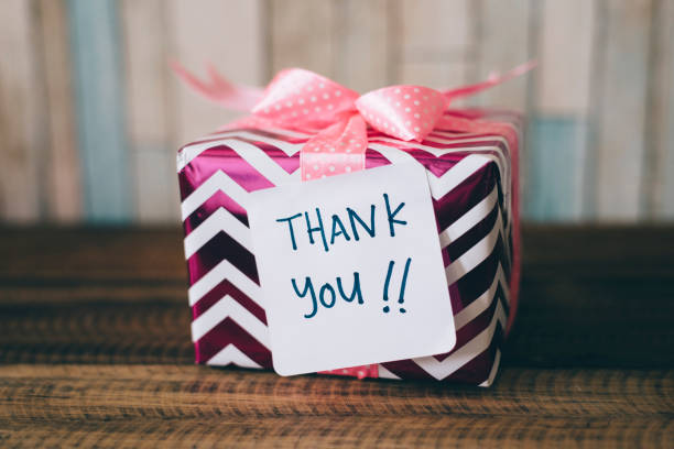 istock present / gift with a thank you note. handwritten thank you note on a gift / present 1169657494