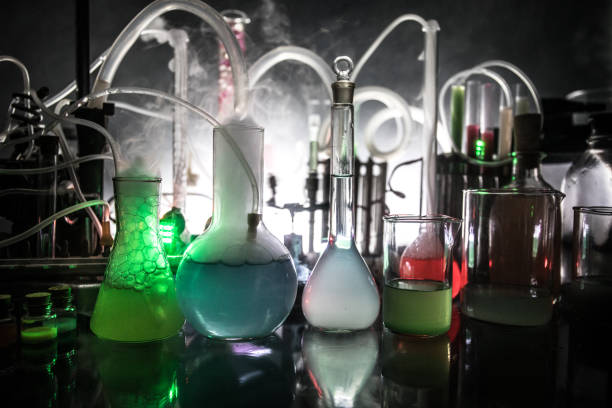 istock Pharmacy and chemistry theme. Test glass flask with solution in research laboratory. Science and medical background. Laboratory test tubes on dark toned background 1169662975