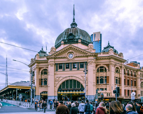 Crowd of people crossing busy intersection near Flinders Street Station Melbourne, Australia - July 28, 2019: Crowd of people crossing busy intersection near Flinders Street Station melbourne street crowd stock pictures, royalty-free photos & images