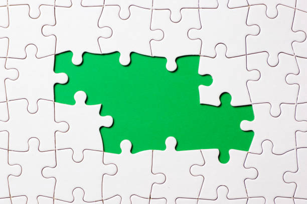 istock Jigsaw puzzle game piece on green background for business theme design 1169664992