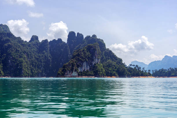 istock Limestone cliffs, islands, and mountain in green lake 1169665821