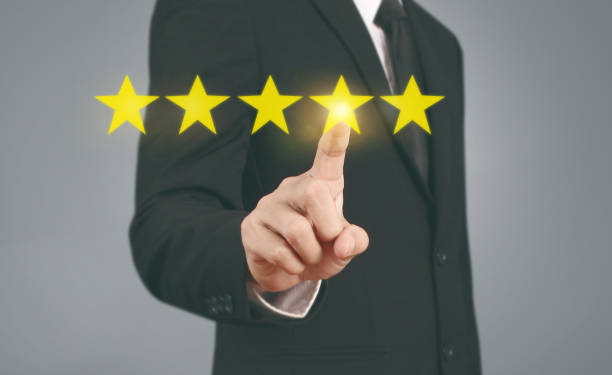 istock Hand touching five star symbol to increase rating 1169666499