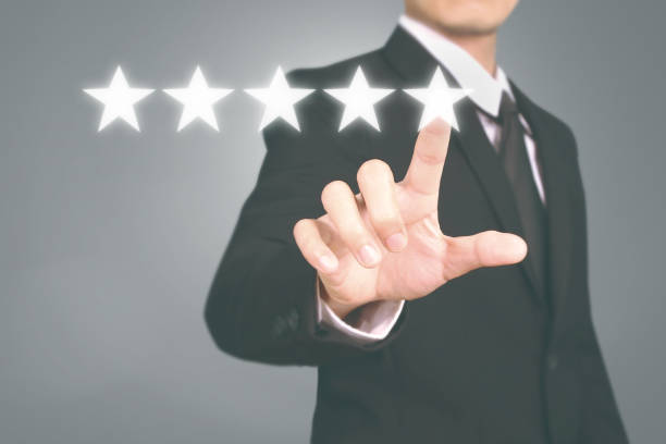 istock Hand touching five star symbol to increase rating 1169666500