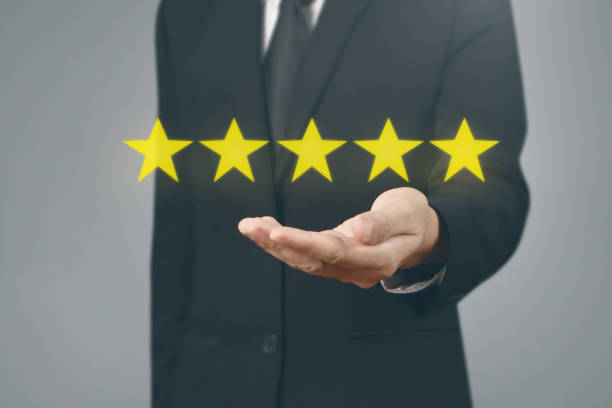istock Hand touching five star symbol to increase rating 1169666505