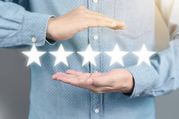 istock Hand touching five star symbol to increase rating 1169666506