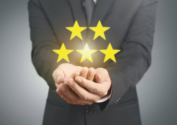 istock Hand touching five star symbol to increase rating 1169666507