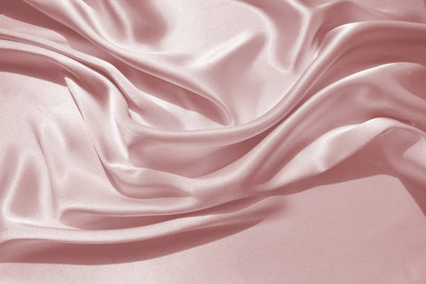 istock Charming smooth satin and silk pink fabric for backgrounds. Elegant abstract upholstery use for holidays 1169667542
