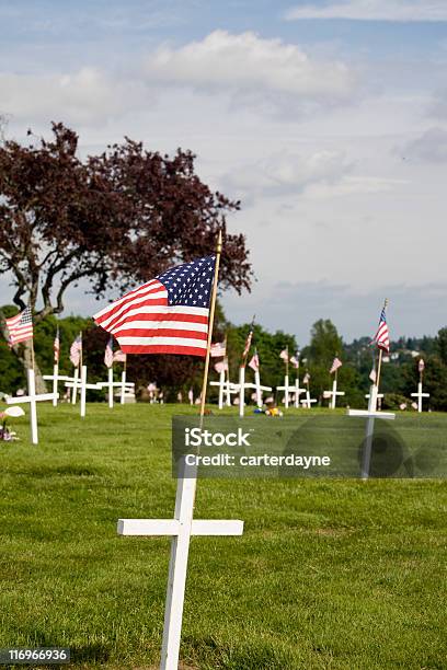 Memorial With White Cross And Us Flag Stock Photo - Download Image Now - American Flag, Blowing, Blue
