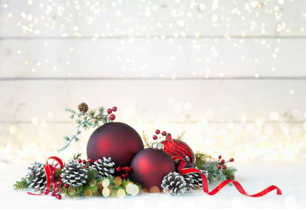 istock Christmas Baubles on a White Wood Background 1169671093