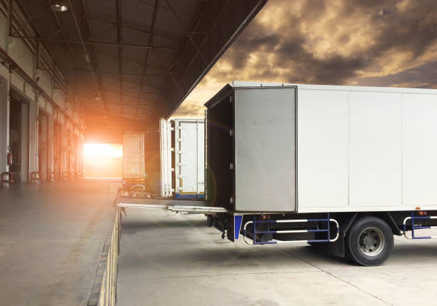 freight transportation, truck docking load cargo at warehouse