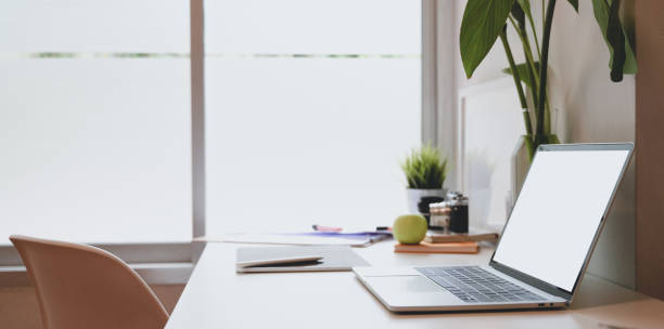 istock Trendy photographer workplace with blank screen laptop 1169673931