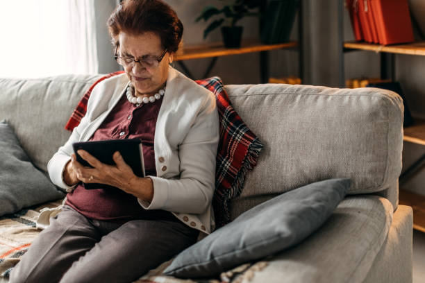 istock Senior woman relaxing with digital tablet 1169674726