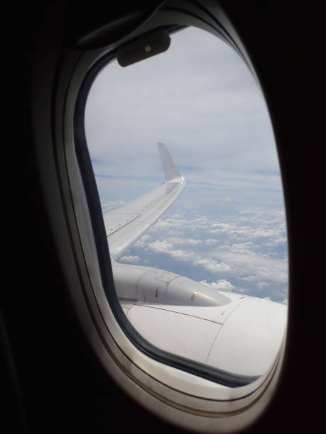 istock Beautiful and stunning view looking through window aircraft during flight in wing with a nice blue sky. 1169680600
