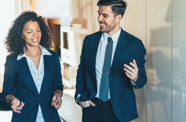 istock Cheerful business persons walking together 1169685610