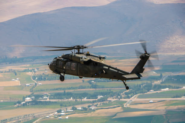 istock military utility helicopter in flight 1169690021