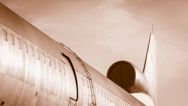 istock airplane exit door and window close up against monotone sky 1169690366