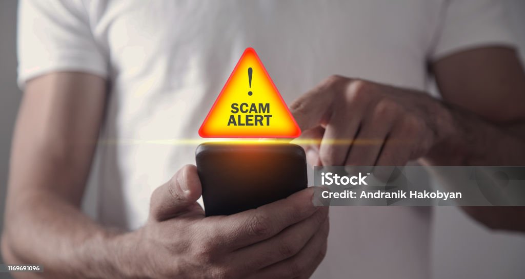 Man holding smartphone. Scam Alert White Collar Crime Stock Photo