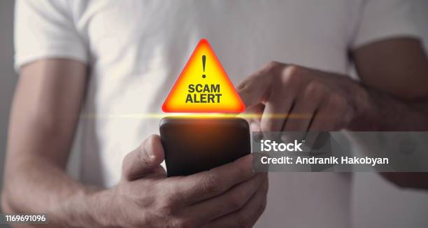 Man Holding Smartphone Scam Alert Stock Photo - Download Image Now - White Collar Crime, Telephone, Alertness