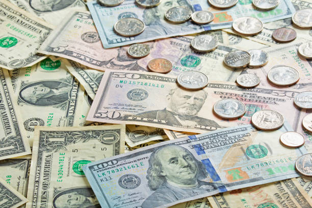 istock American bank notes and coins for use as a background 1169691132