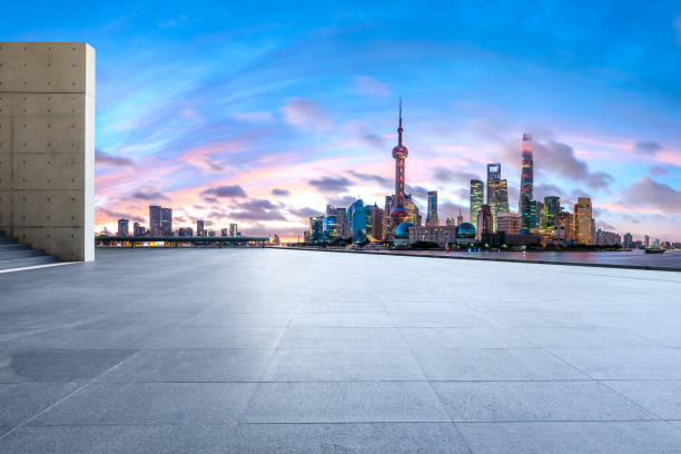 istock Shanghai skyline and modern buildings with empty square floor at sunrise 1169691309