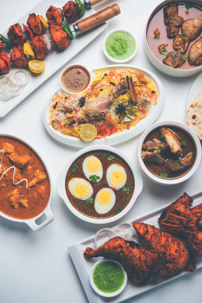 istock Assorted Indian Non Vegetarian food recipe served in a group. Includes Chicken Curry, Mutton Masala, Anda/egg curry, Butter chicken, biryani, tandoori murg, chicken-tikka and naan/roti 1169692038