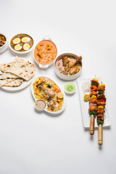 istock Assorted Indian Non Vegetarian food recipe served in a group. Includes Chicken Curry, Mutton Masala, Anda/egg curry, Butter chicken, biryani, tandoori murg, chicken-tikka and naan/roti 1169693073