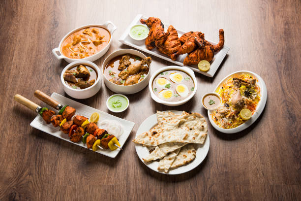 istock Assorted Indian Non Vegetarian food recipe served in a group. Includes Chicken Curry, Mutton Masala, Anda/egg curry, Butter chicken, biryani, tandoori murg, chicken-tikka and naan/roti 1169694366