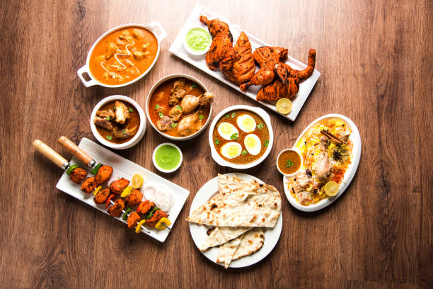istock Assorted Indian Non Vegetarian food recipe served in a group. Includes Chicken Curry, Mutton Masala, Anda/egg curry, Butter chicken, biryani, tandoori murg, chicken-tikka and naan/roti 1169694473