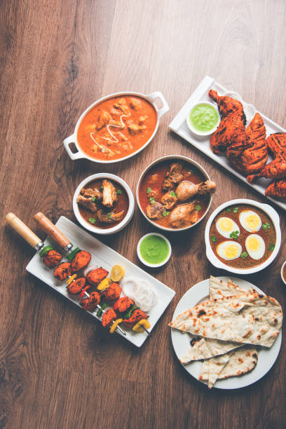 istock Assorted Indian Non Vegetarian food recipe served in a group. Includes Chicken Curry, Mutton Masala, Anda/egg curry, Butter chicken, biryani, tandoori murg, chicken-tikka and naan/roti 1169694663