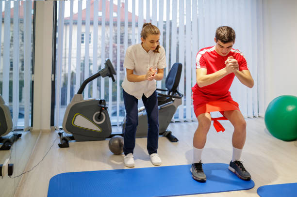 istock Medical assistant encouraging patient doing squats 1169694778