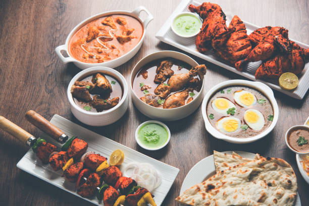 istock Assorted Indian Non Vegetarian food recipe served in a group. Includes Chicken Curry, Mutton Masala, Anda/egg curry, Butter chicken, biryani, tandoori murg, chicken-tikka and naan/roti 1169694795