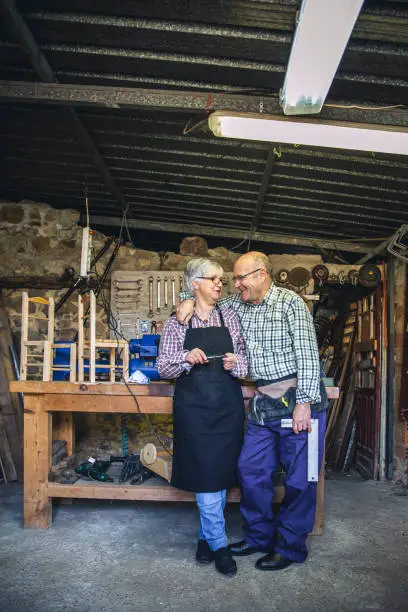 Portrait of senior couple in a carpentry workshop